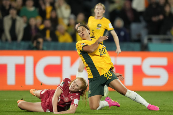 Sam Kerr challenges with Denmark’s Stine Ballisager.