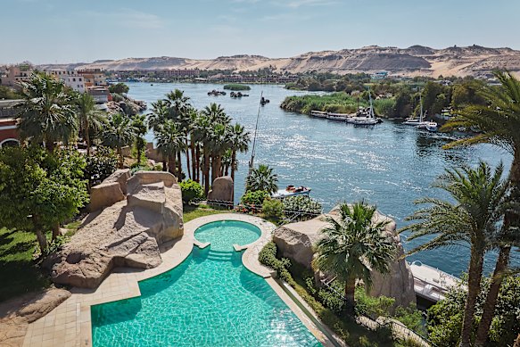 The hotel is perched on granite cliffs overlooking islands in the River Nile.