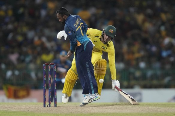 Australia’s Alex Carey completes a run as Sri Lanka’s Charith Asalanka watche.