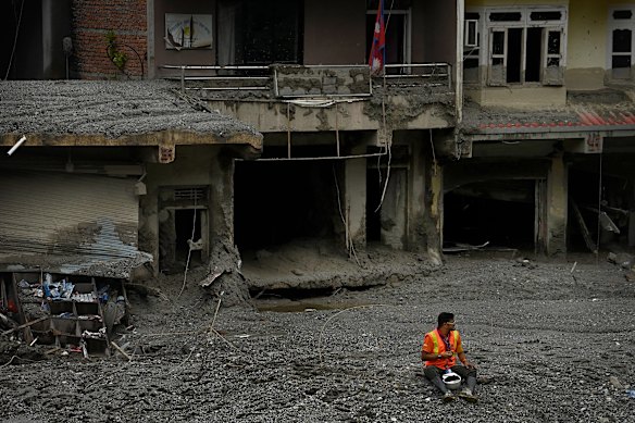 The Nepalese army, police and ministry volunteers search Dhunge after it was impacted by the Nepal flood disaster. 