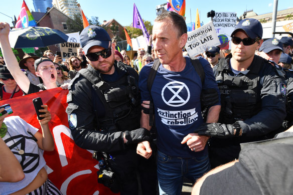 Police arrest an Extinction Rebellion protester after the intersection of Margaret and William streets in Brisbane was blocked earlier this month.