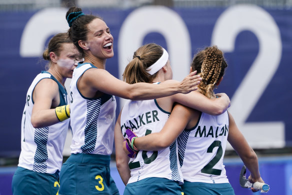 Rosie Malone (right) celebrates with Emily Chalker and Brooke Peris after scoring against China.