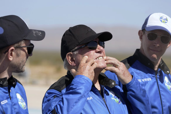 William Shatner (centre) describes what the G-forces of the Blue Origin lift-off did to his face as Chris Boshuizen (left) and Glen de Vries look on.