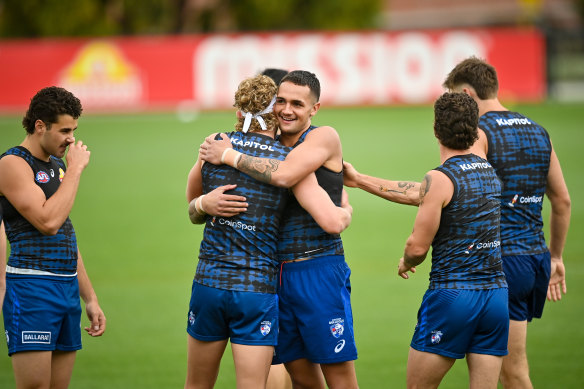 Ugle-Hagan is welcomed back by teammate Aaron Naughton.