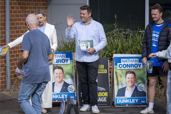 Liberal candidate, Nathan Conroy, greets voters alongside deputy Liberal leader Sussan Ley at a polling booth in Carrum Downs.