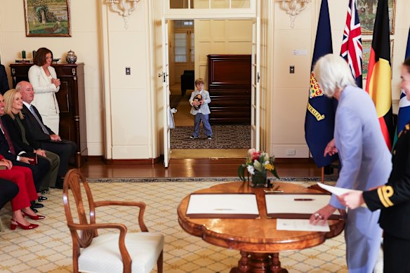 Minister for Communications and Sport Anika Wells’ son with a footy at Government House on Tuesday morning.