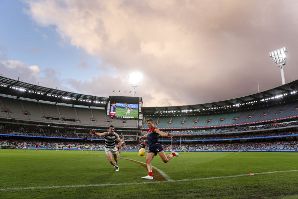 Jake Melksham gets a kick away for the Demons on a wet and wintry afternoon at the MCG.