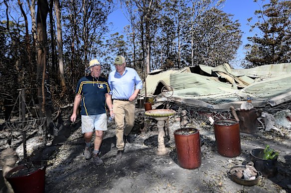 Property owner Stuart Skeen walks with Prime Minister Scott Morrison through his burnt-out property at Binna Burra in the Gold Coast Hinterland on Friday, September 13, 2019. 
