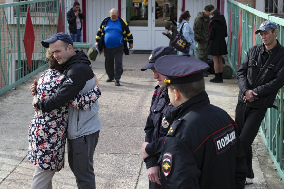 A Russian recruit hugs his mother at a military recruitment centre in Volgograd.