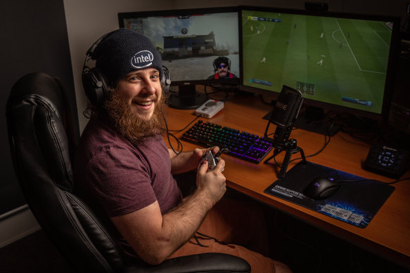 James 'CripsyTV' Williams playing FIFA at his workstation.