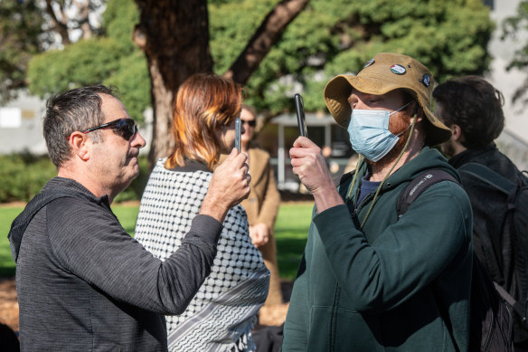 Stand-off: A supporter of Israel and a supporter of Palestine film each other at Monash on Wednesday.