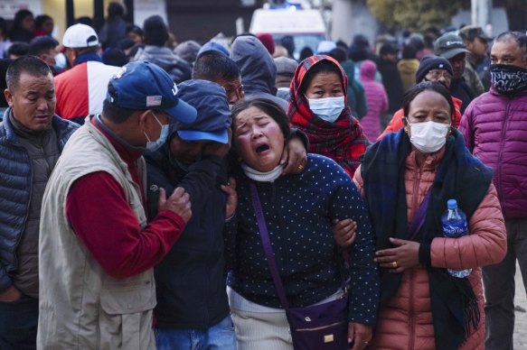 A woman cries as the body of a relative, victim of a plane crash, is brought to a hospital in Pokhara, Nepal, on Sunday.