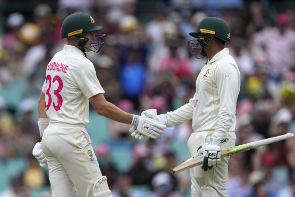 Usman Khawaja (right) congratulates Marnus Labuschagne on his half-century shortly before himself following suit.