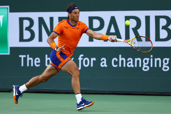 Rafael Nadal plays a forehand against Taylor Fritz. 