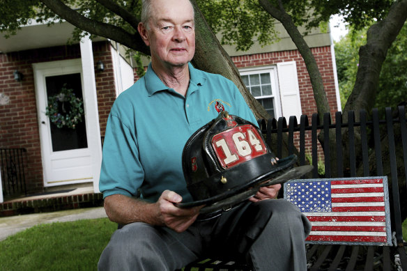 Beckwith poses with the helmet he wore in the original photograph at his home in 2006.