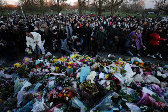People gather at the bandstand on Clapham Common in memory of Sarah Everard, after the official March 2021 vigil was cancelled.