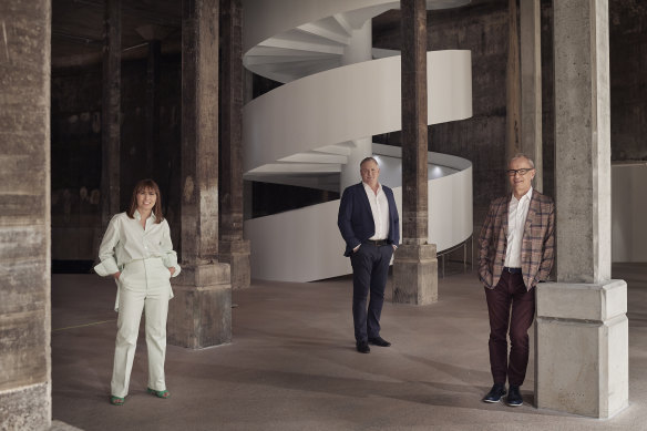Art Gallery of NSW director Michael Brand (right) with his deputy Maud Page (left) and head of development John Richardson in the Tank, a giant underground space which stored oil during World War II and is now a 2200-square-metre exhibition space, one of the jewels in the Sydney Modern crown.