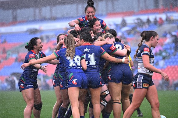 The Warriors celebrate a try against the Cowboys in Newcastle.