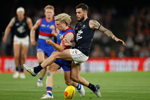 Cody Weightman of the Bulldogs and Zac Williams of the Blues compete for the ball.