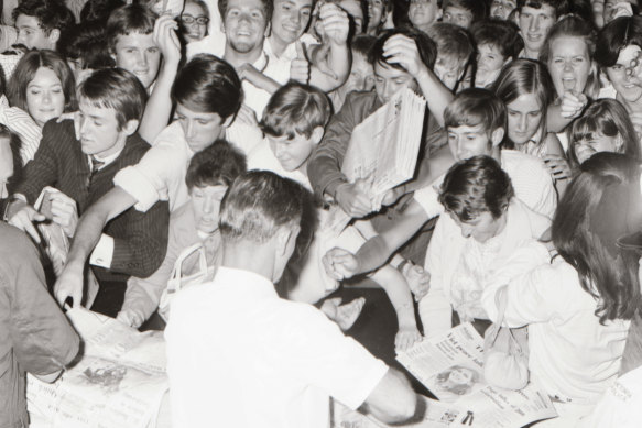 Students and parents anxious to get copies of The Age with the supplement listing the 1968 matriculation exam results mob staff manning make-shift counters set up in the loading dock of The Age Collins Street building.