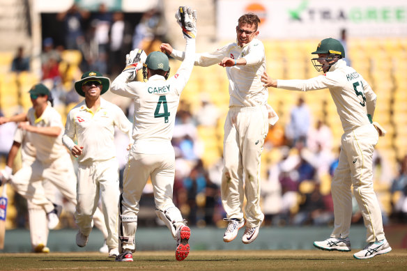Todd Murphy celebrates taking the wicket of Virat Kohli on the way to a five-wicket haul.