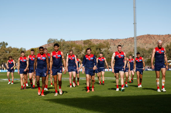 The dejected Demons traipse off Traeger Park in Alice Springs after Sunday’s 92-point loss. 