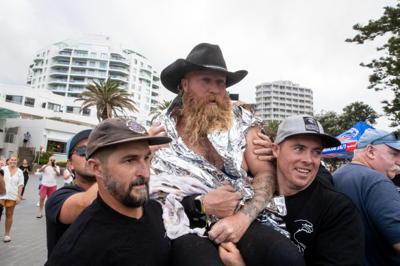 Former pro-surfer Blake Johnston leaves the water after the mammoth surf session.