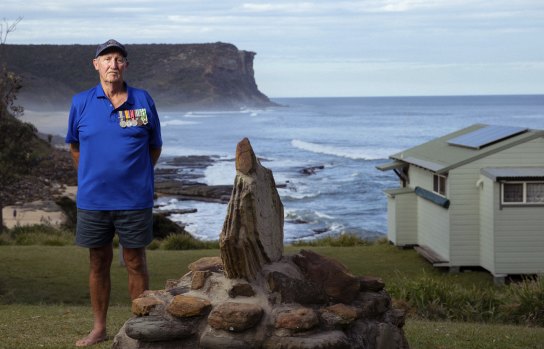 Vietnam War veteran Tim Strange stands next to the memorial at Little Garie Beach.
