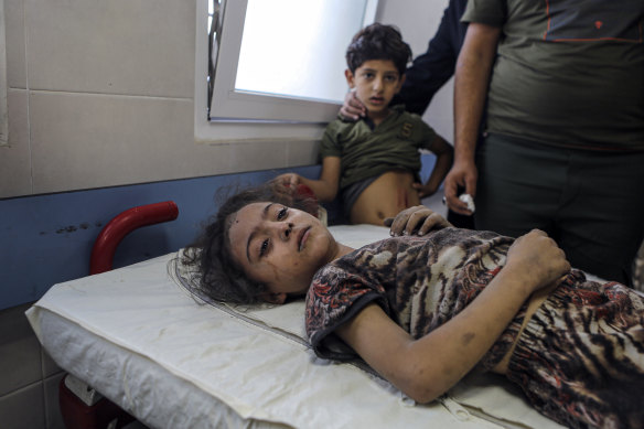 A wounded Palestinian girl receives treatment at al-Shifa hospital, following Israeli airstrikes on Gaza City.