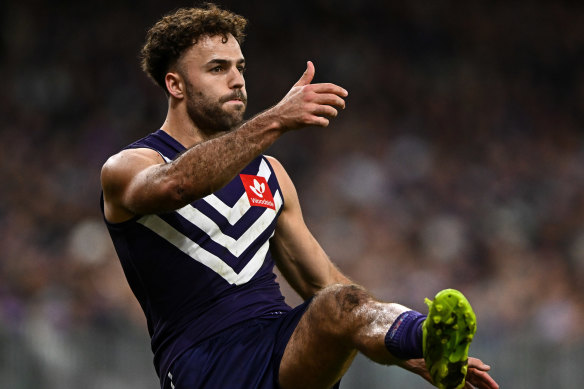 Griffin Logue gets a kick away for Fremantle during the finals.