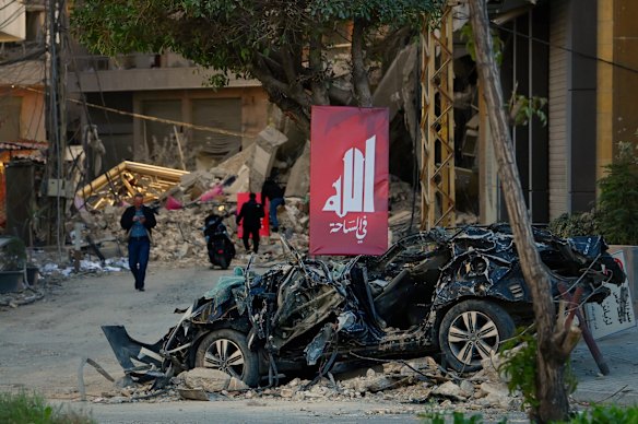 Un'auto distrutta si trova vicino alla scena di un attacco aereo israeliano a Dahiyeh, nel sud di Beirut.