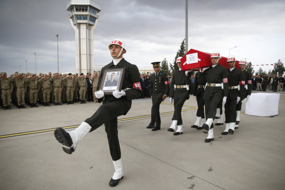 Turkish soldiers carry the Turkish flag-draped coffin of soldier Sefa Findik killed in action in Syria earlier in the day, in Sanliurfa, southeastern Turkey, on Sunday.