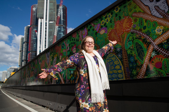 Colourful character: Artist Emily Crockford celebrates the installation of her new work.