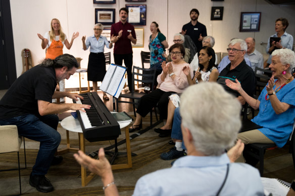 "The music floats up": choirmaster Robert Teicher, on keyboards, leads the Chris O'Brien Lifehouse choir that includes former science teacher Michael Tapsell, second from right, and long-time Play School presenter Benita Collings, right.