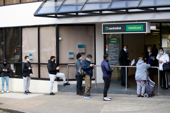 Thousands of people queued at Centrelink offices in early 2020 before the government introduced JobKeeper.