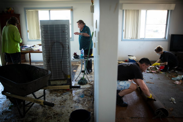 Volunteers and family clear Kim Rees’ father’s home.