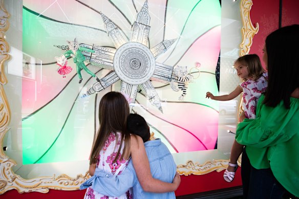 Emily Smith with her children, Charlotte, 8, Louis, 5, and Amelia, 3, looking at David Jones Christmas windows in Sydney. 