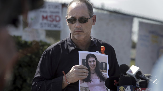 Fred Guttenberg, father of Jaime Guttenberg, with a picture of his daughter as parents of the victims of the Valentine's Day shooting read a prepared statement, calling on the state’s Legislature to pass a bill they believe will improve school security. 