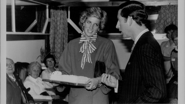 Prince Charles and Diana in London. The Princess was given a cake and joked with Prince Charles as she asked, "Is there rum in it?".