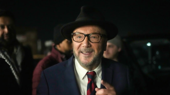 Workers Party of Britain candidate George Galloway celebrates with supporters at his campaign headquarters after being declared the winner in the Rochdale by-election.