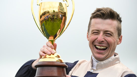 Harry Coffey poses with the trophy after riding Duke De Sessa to victory in the Caulfield Cup.