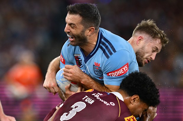 James Tedesco is tackled by Robert Toia.