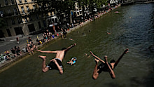 Parisians bath in the Canal Saint-Martin in Paris.