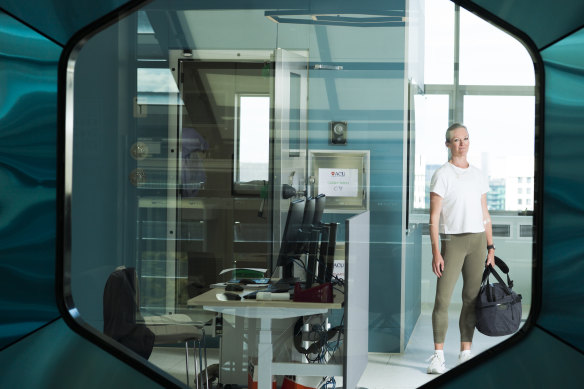 Journalist Sarah Berry outside the metabolic chamber at the Australian Catholic University, Melbourne. Being inside it is like being on a plane to nowhere, she says, “yet I’m aware it could transport some people towards a new and healthier life.”