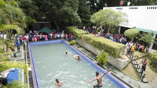 Protesters make use of the swimming pool in the Sri Lankan president’s official residence in Colombo.