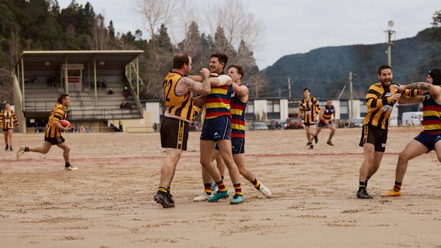 Game On: A player (at left) seizes the moment during a skirmish on the infamous gravel surface at Queenstown, Tasmania, home of the Queenstown Crows.