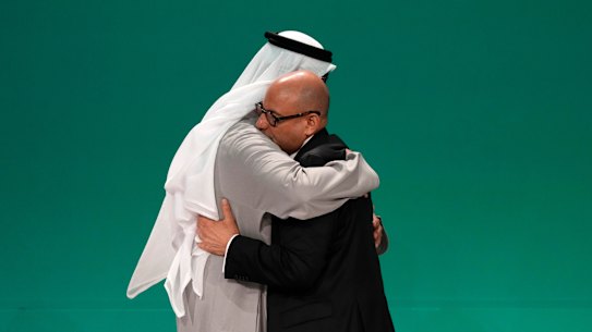 United Nations Climate Chief Simon Stiell, right, and COP28 President Sultan al-Jaber embrace at the COP28