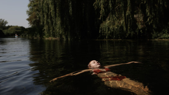 A girl floating in the River Great Stour in Britain in August.