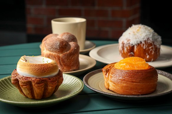 Pastries at Daybaker, clockwise from front left: lemon meringue tart, morning bun, bomba Calabrese and a round pastry filled with blood orange cream, lemon financier and mandarin segments.