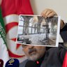 Iranian ambassador to Tunisia Mir Massoud Hosseinian shows an image of damage to Tehran’s historic Golestan Palace.